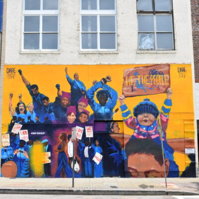 Dare To Dissent mural in downtown Raleigh featuring iconic protests