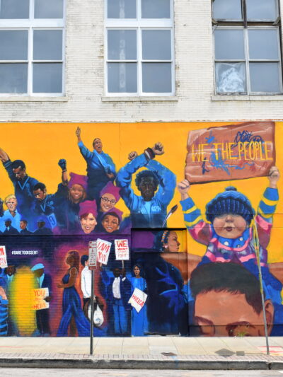 Dare To Dissent mural in downtown Raleigh featuring iconic protests