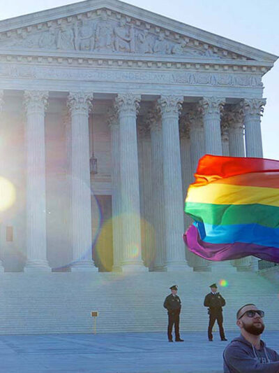 Man waving rainbow flag in front of Supreme Court