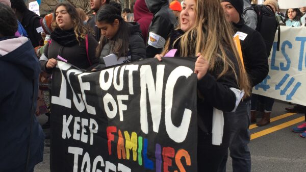 "Keep families together" sign at a rally