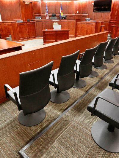 Image of an empty jury box in a courtroom