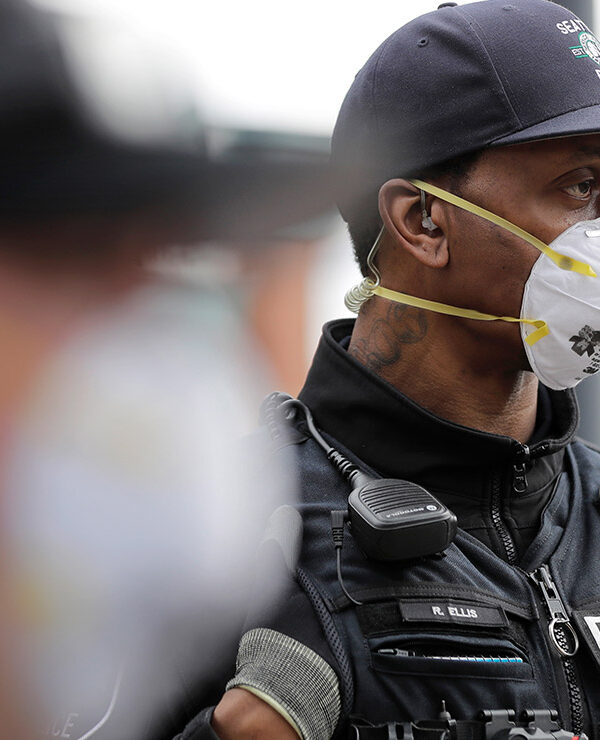 Two Seattle police officers wearing N95 masks.
