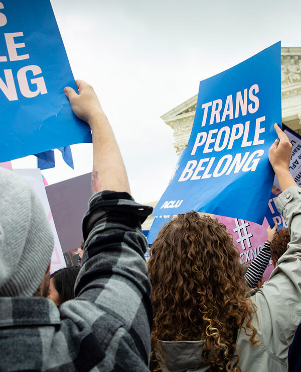 Demonstrators outside the Supreme Court with signs advocating for the rights of LGBTQ people.