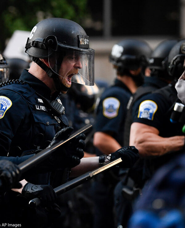 Police in riot gear shouts in black protestor's face as demonstrators gather to protest the death of George Floyd near the White House