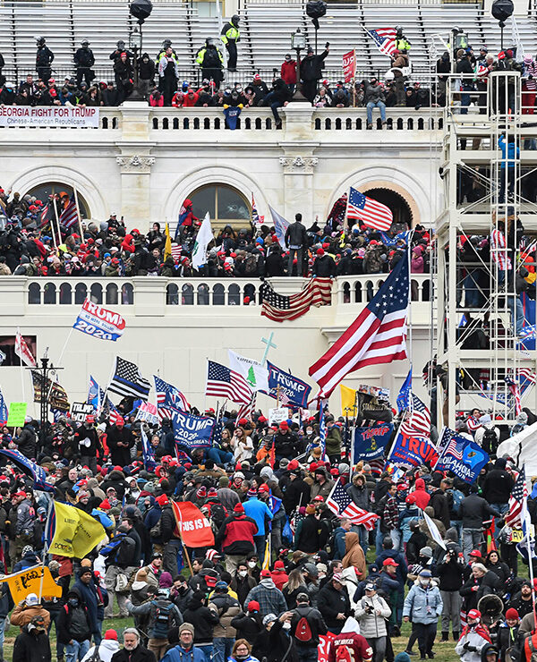 Insurrectionists amassing on the steps, walls, balconies, and grounds of the Capitol Building.