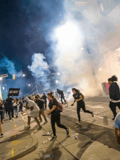 Protesters scramble on Fourth Street as police fire tear gas on either side of the protesters in uptown Charlotte on June 2, 2020. JOSHUA KOMER THE CHARLOTTE OBSERVER