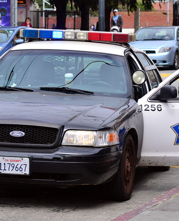 Modern SFPD police car cruiser with the door on the driver side open.