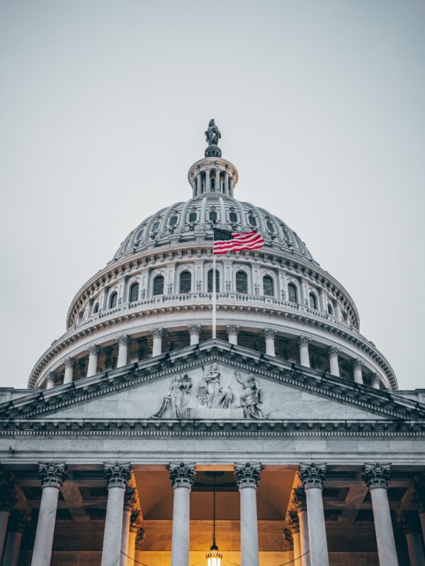 Photo of the U.S. Capitol with the flag waving in front.