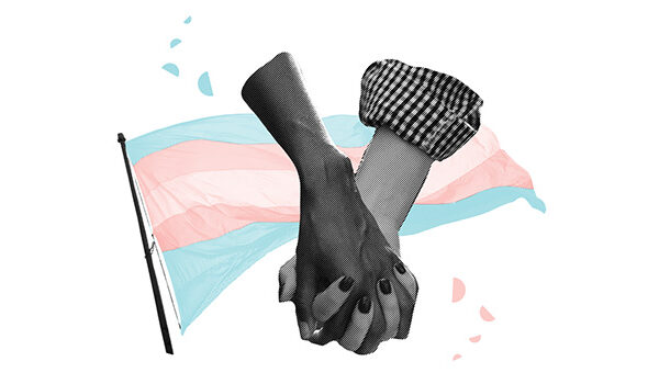 Two arms holding hands in front of the trans pride flag
