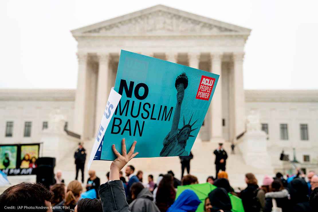 In this April 25, 2018 photo, a person holds up a sign that reads "No Muslim Ban" during an anti-Muslim ban rally at the Supreme Court