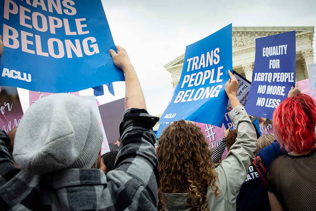 Demonstrators outside the Supreme Court with signs advocating for the rights of LGBTQ people.