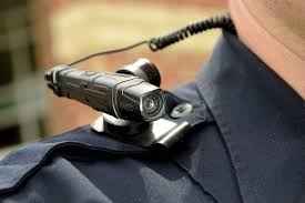 Body camera rests on top of officer's shoulder