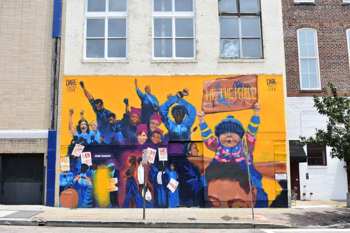 Dare To Dissent mural in downtown Raleigh featuring iconic protests