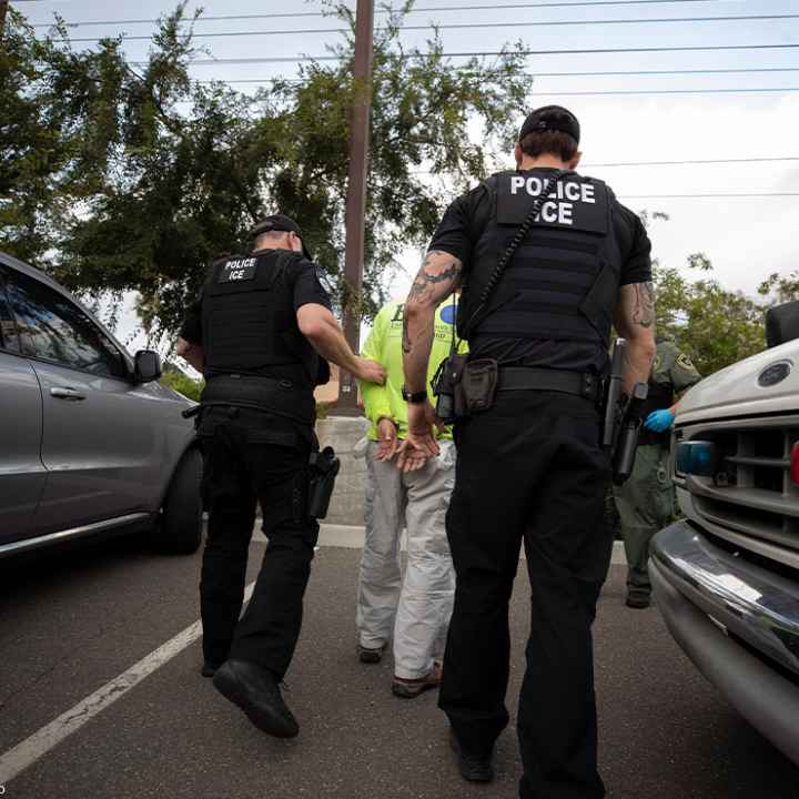 On a sunny day in California, two Immigration and Customs Enforcement (ICE) officers escort a man in handcuffs. Trump administration officials have confirmed plans for two new tactics in their anti-immigrant agenda.
