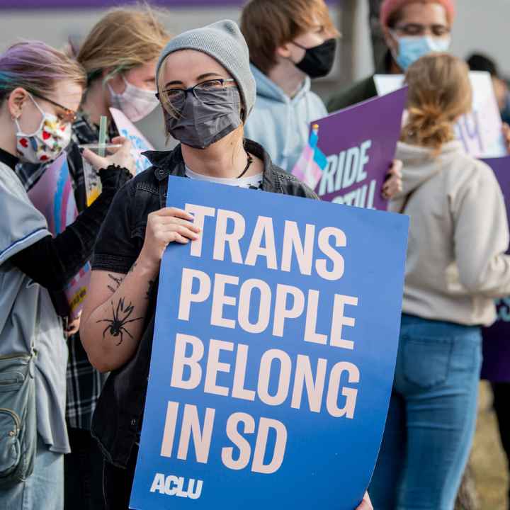 Protestor holds sign reading “Trans People Belong In SD” during trans rights rally.