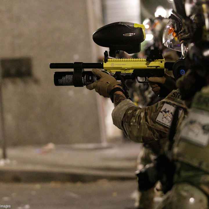Federal SRT officers shoot less-lethal munitions at protesters.