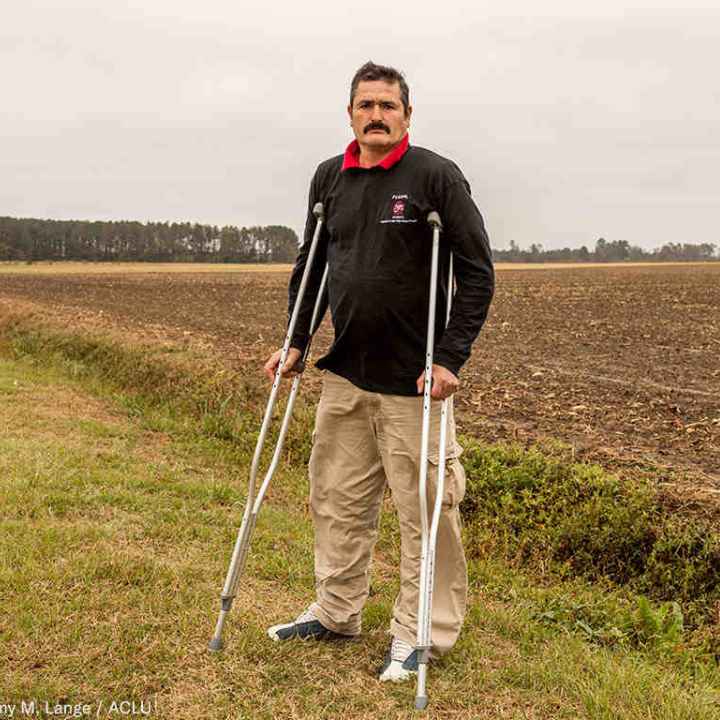 Arturo Hernandez, a farmworker from Mexico and a FLOC member. Hernandez, who works in Samson County, N.C., was recently injured on the job. (Photo: Jeremy M. Lange) Arturo Hernandez stands on crutches in a field in North Carolina.