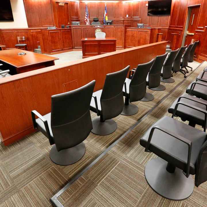 Image of an empty jury box in a courtroom